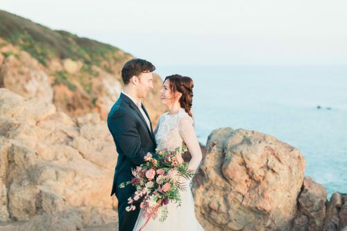 A happy couple after their wedding by the sea