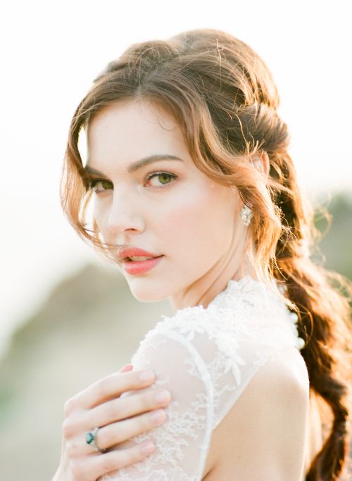 A beautiful bride wearing a Topazery vintage engagement ring and earrings by Lindsay Marie Design